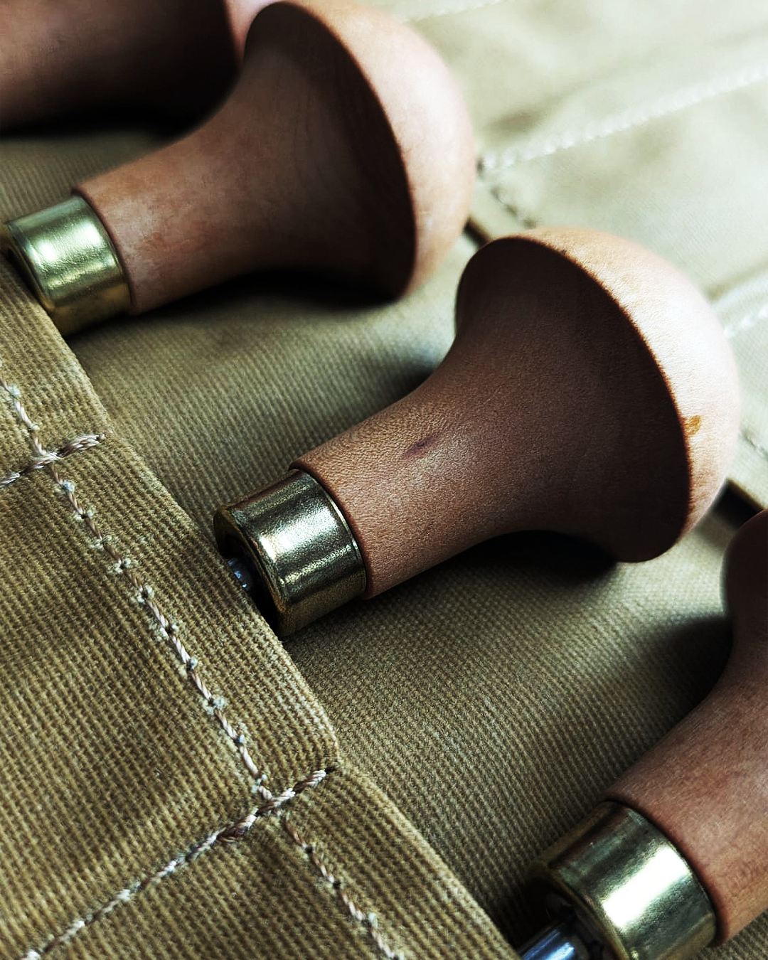 Linocut gouges stored in a canvas case, slow craft tools for forestcore printmaking.